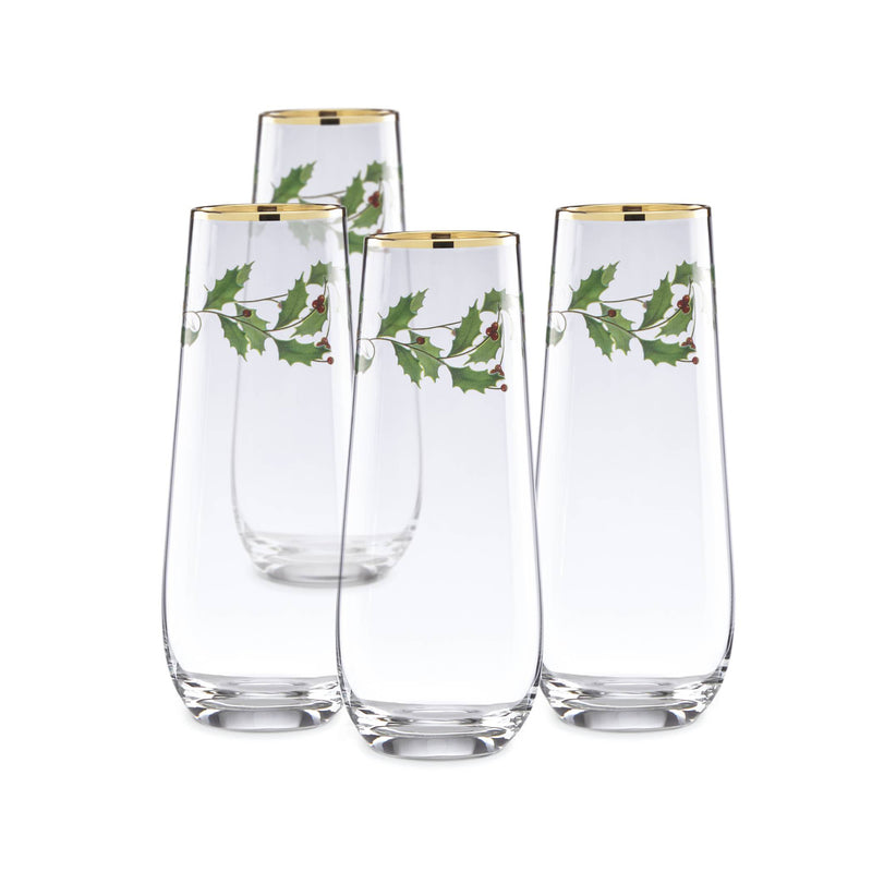 Set of 4 stemless flutes with gold rim and holly leaf decal, clear glass.