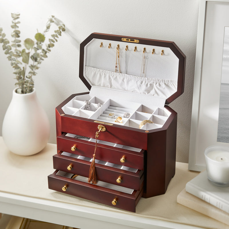 Mahogany locking jewelry box, open with ring trays, necklace slots, and stacked drawers