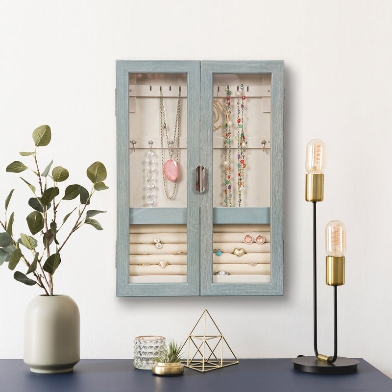 Gray-finish hanging jewelry cabinet mounted with open doors and visible necklace and ring storage