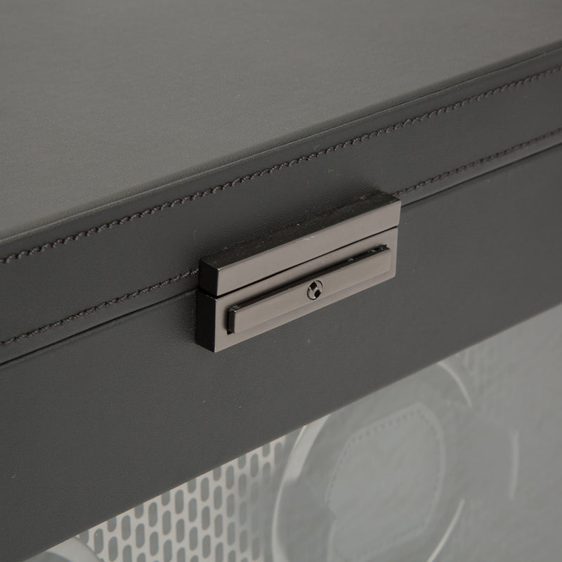 Close-up of rectangular latch on the front of a black watch winder box