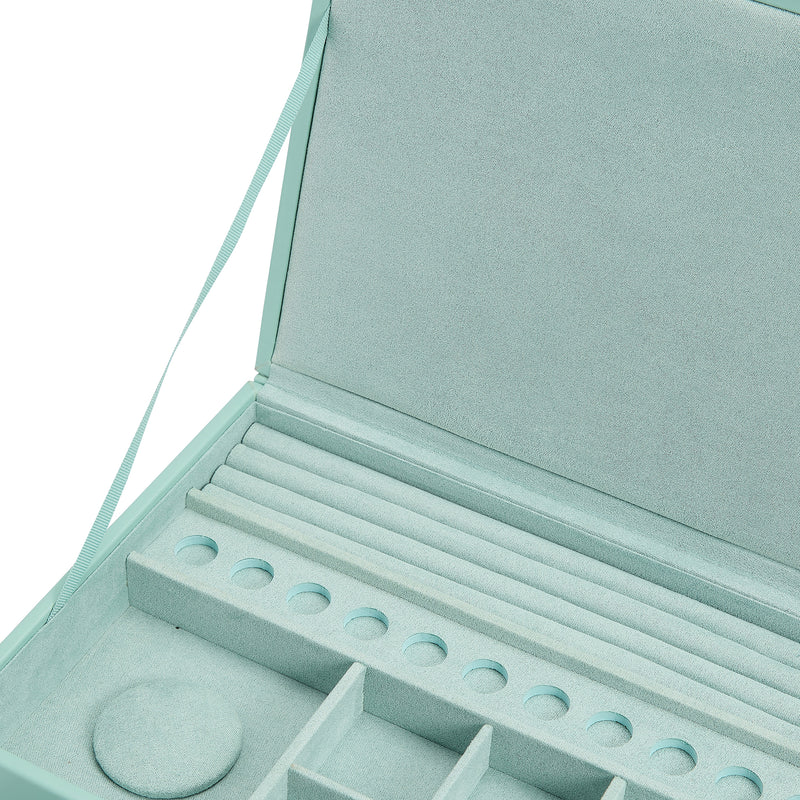Open jewelry box interior with padded compartments and ring holes on tray