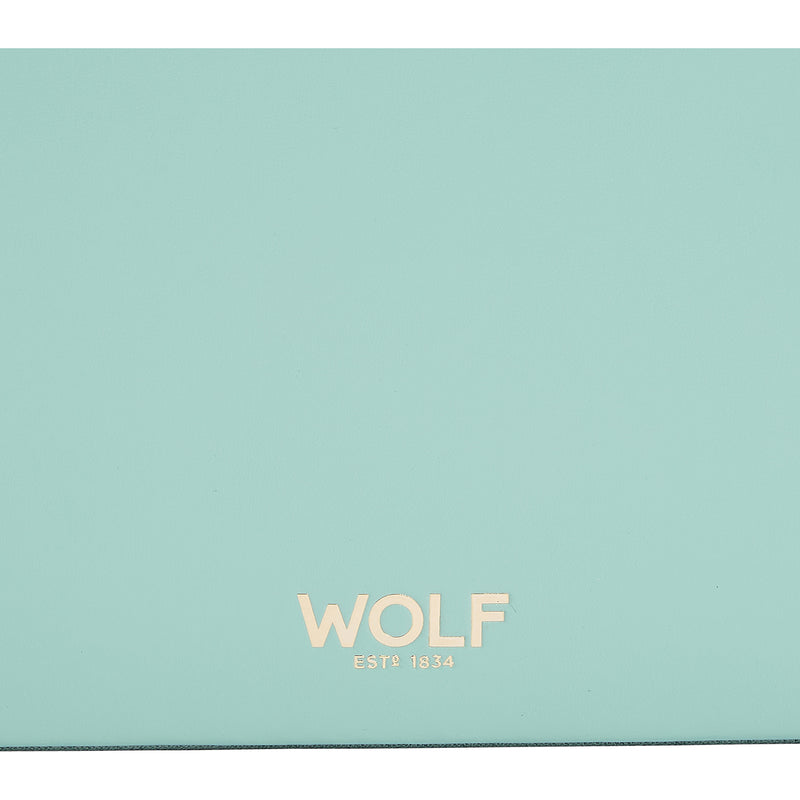 WOLF gold logo on jade green leather lid surface
