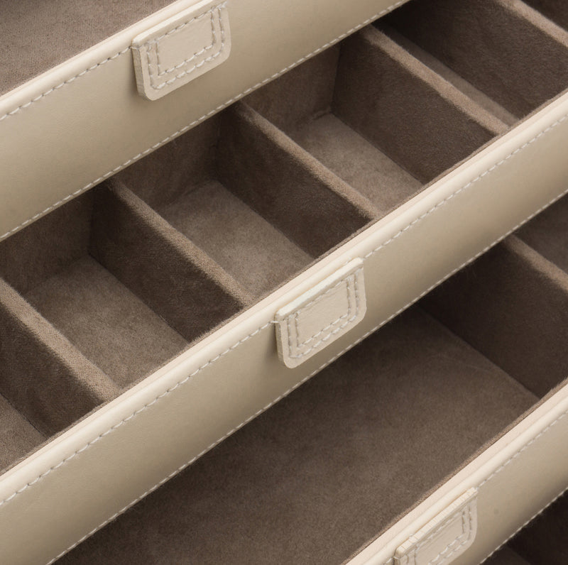 Interior view of ivory jewelry box showing gray felt-lined compartments