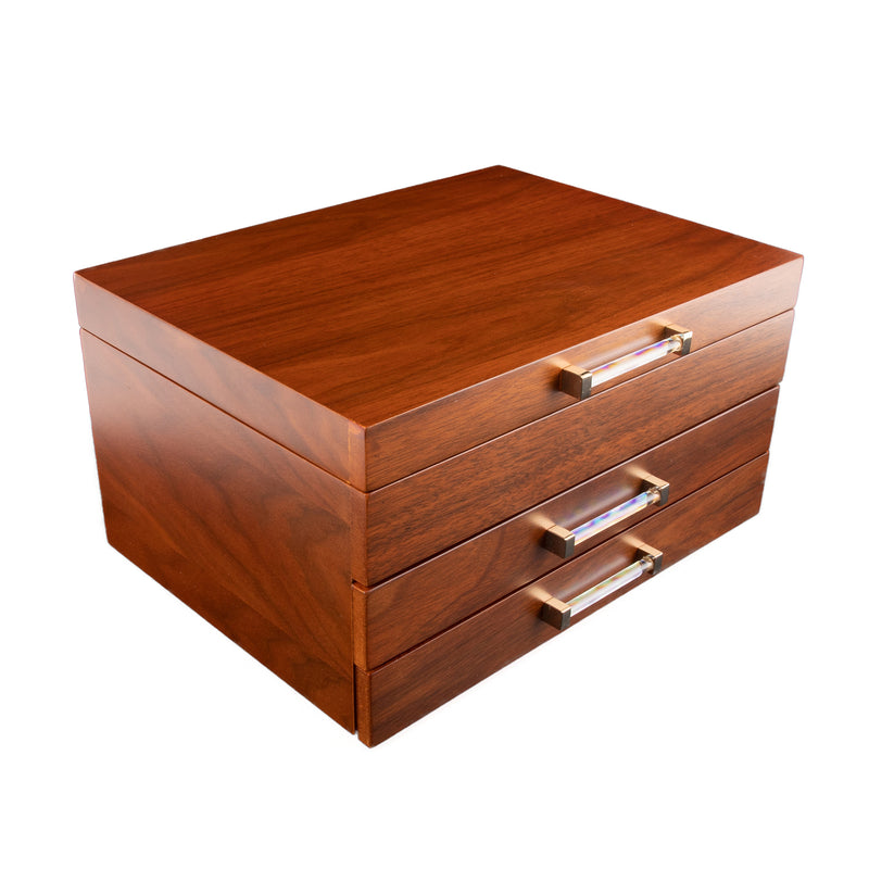 Walnut wood jewelry box with two drawers and brushed metal handles, lid closed