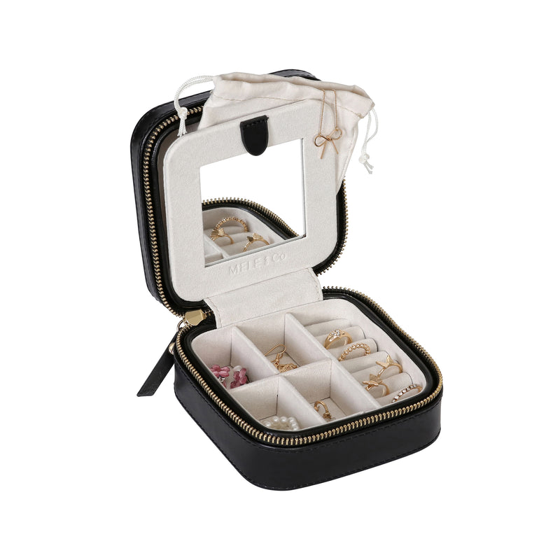Black square travel jewelry box in vegan leather with open zip lid and divided compartments