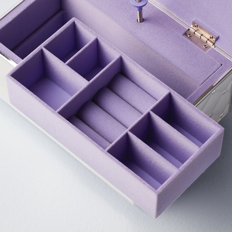 Open musical jewelry box with purple padded compartments and hinged lid