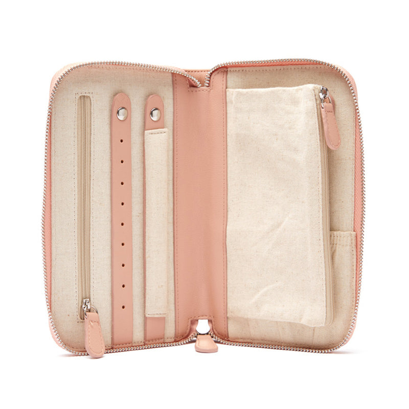 Pink faux leather travel jewelry wallet, open with ring slots and padded compartments