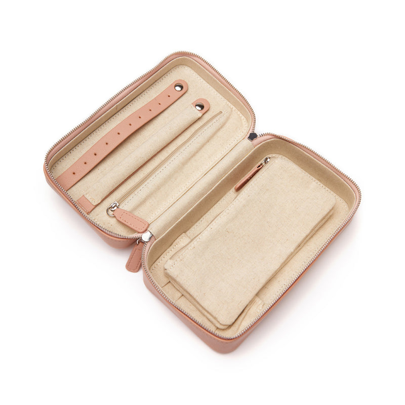 Medium blush faux leather travel jewelry case, open with padded slots and snap pockets