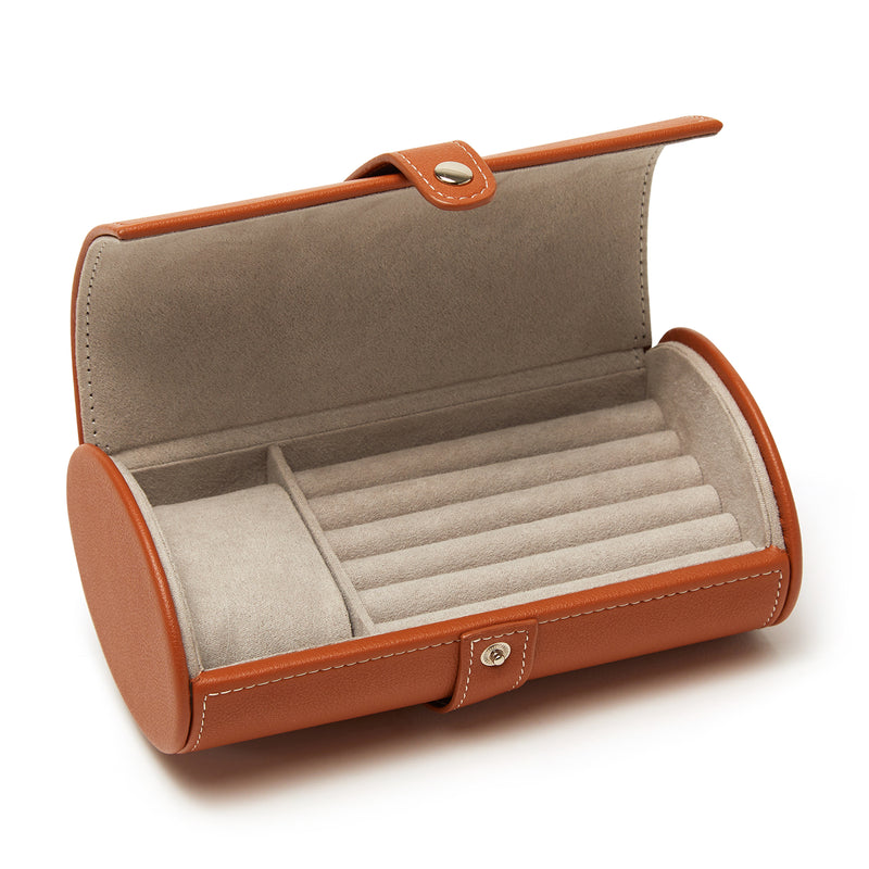 Brown faux leather travel jewelry roll with snap strap, open compartments and ring slots.