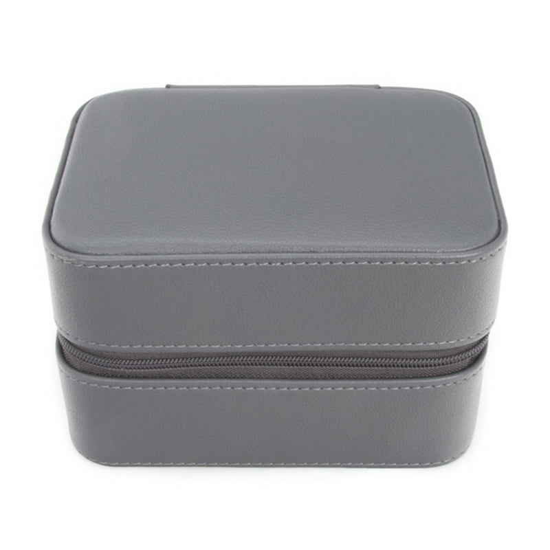 Gray faux leather travel jewelry case with zip closure, rounded lid