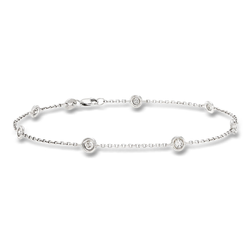 14kt white gold diamond bracelet with three round bezel-set stones and chain links