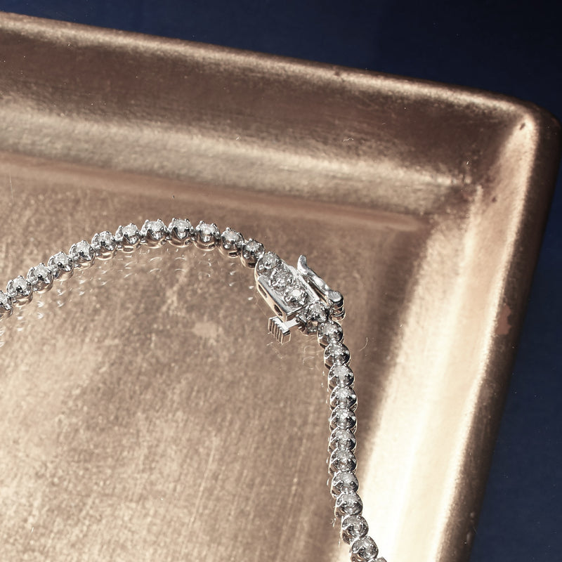 14kt white gold graduated diamond tennis necklace with prong-set clasp detail
