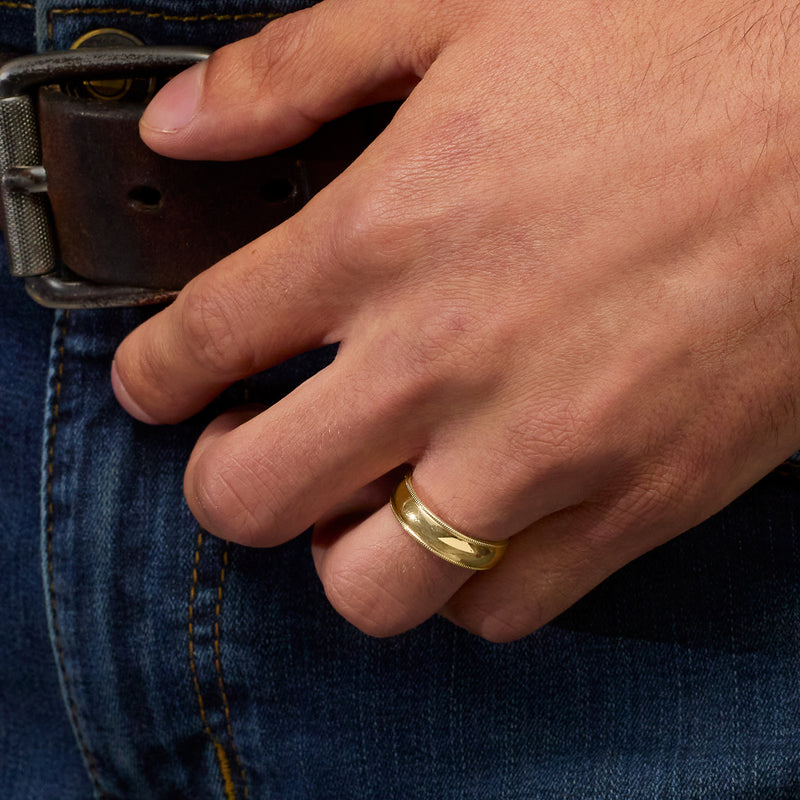 Yellow gold milgrain ring on finger with smooth polished profile