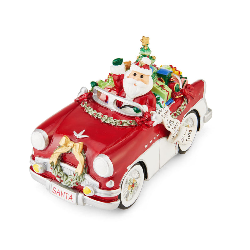 Red Santa musical figurine in decorated vintage car with gifts and toy tree