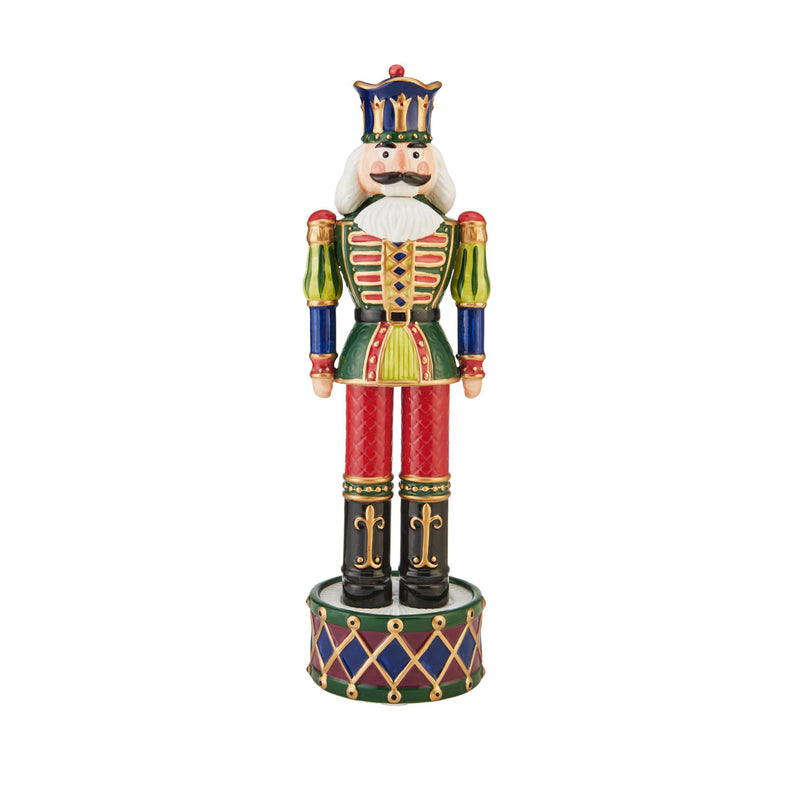 Prince nutcracker figurine with tall crown, white beard, green coat, red pants on drum base