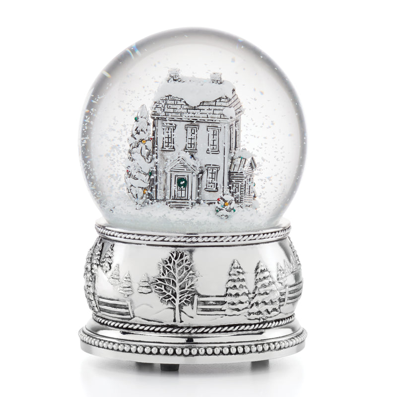 Reed & Barton farmhouse snow globe with silver base, winter house scene inside the clear sphere.