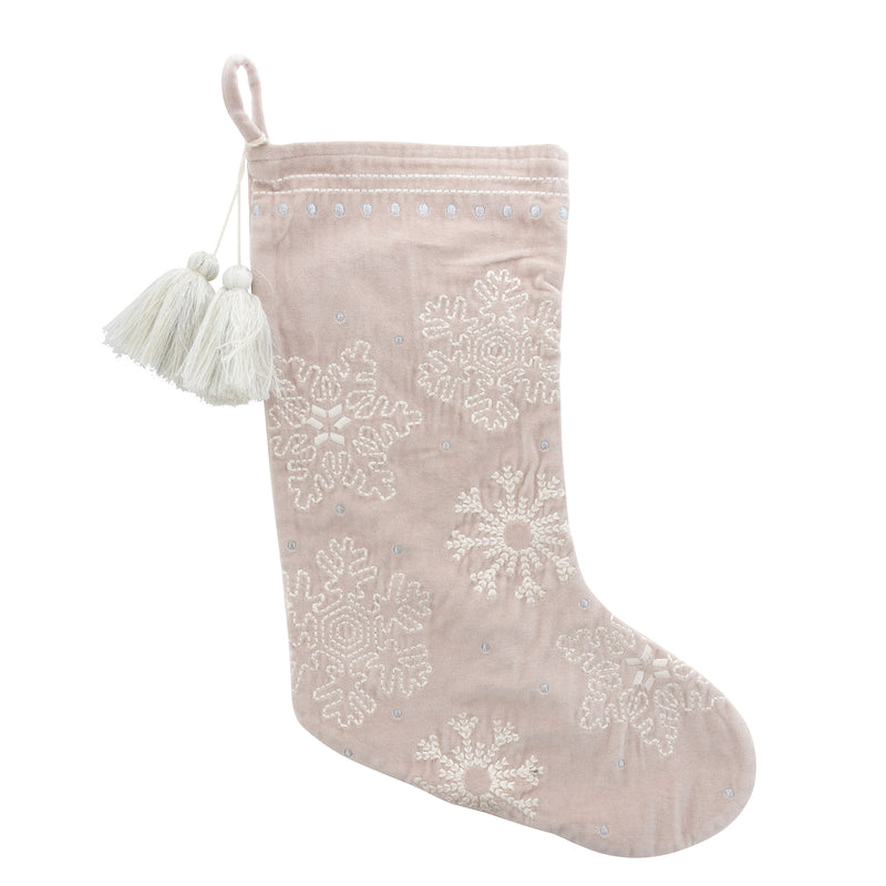 Cream velvet holiday stocking with white snowflake pattern and tassel cuff