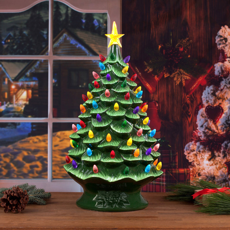 Green nostalgic tabletop Christmas tree with multicolored lights and star topper