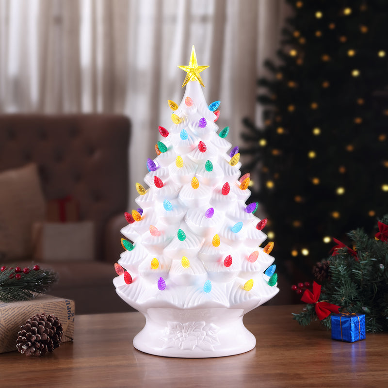 White tabletop Christmas tree decoration with star topper and multicolored lights