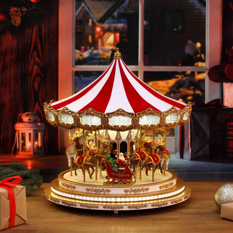 Gold and red holiday carousel decoration with miniature figures and horses, lit base