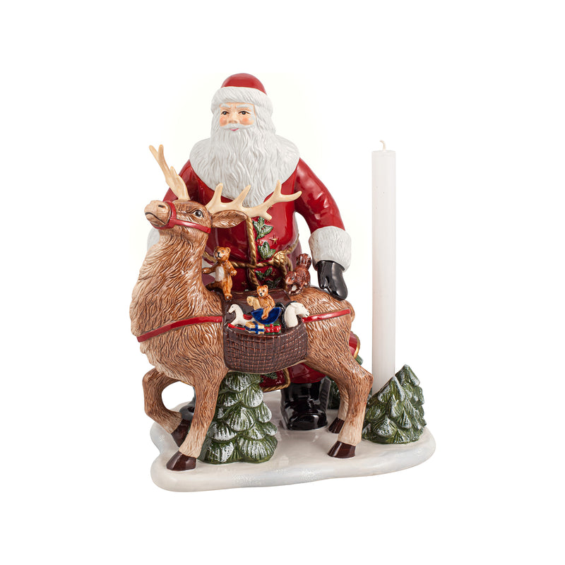 Christmas Santa figurine holding a brown deer, with candle and small gifts