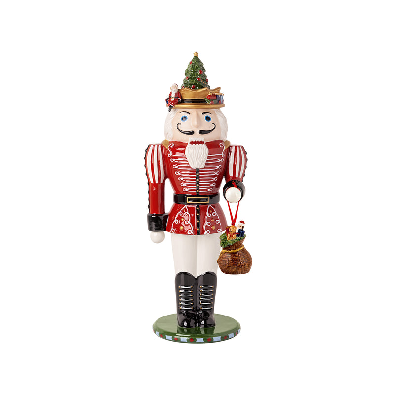 Christmas nutcracker figurine with red striped coat, green hat, and white beard