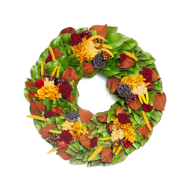 Dried golden aubergine wreath with green leaves, yellow flowers, and dark purple accents