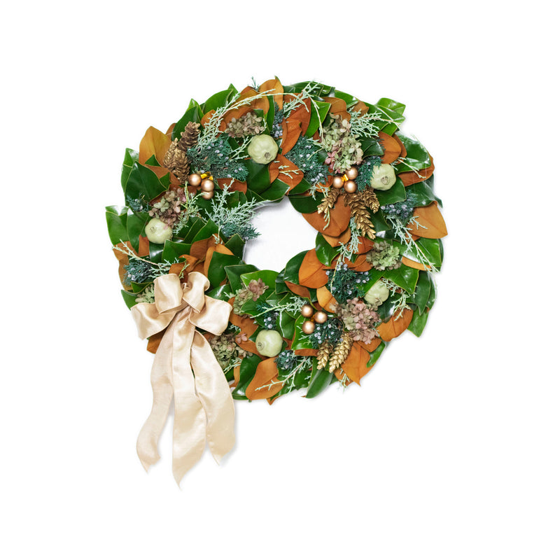 Fresh wreath with green foliage, orange-brown ribbons, pine accents, and gold ornaments