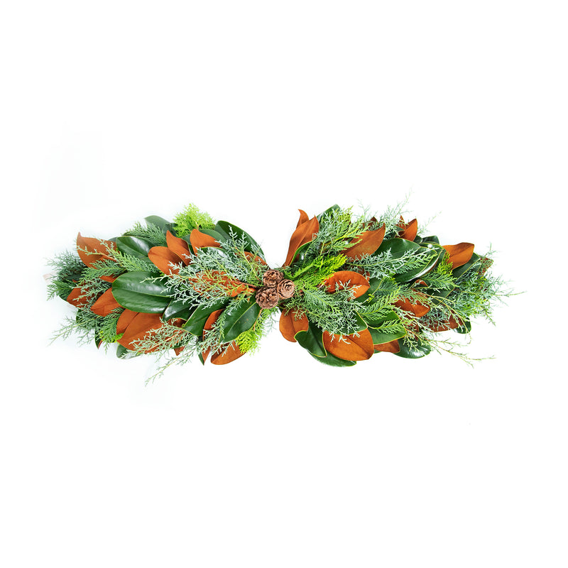 Floral centerpiece with green leaves, orange blooms, and white filler flowers