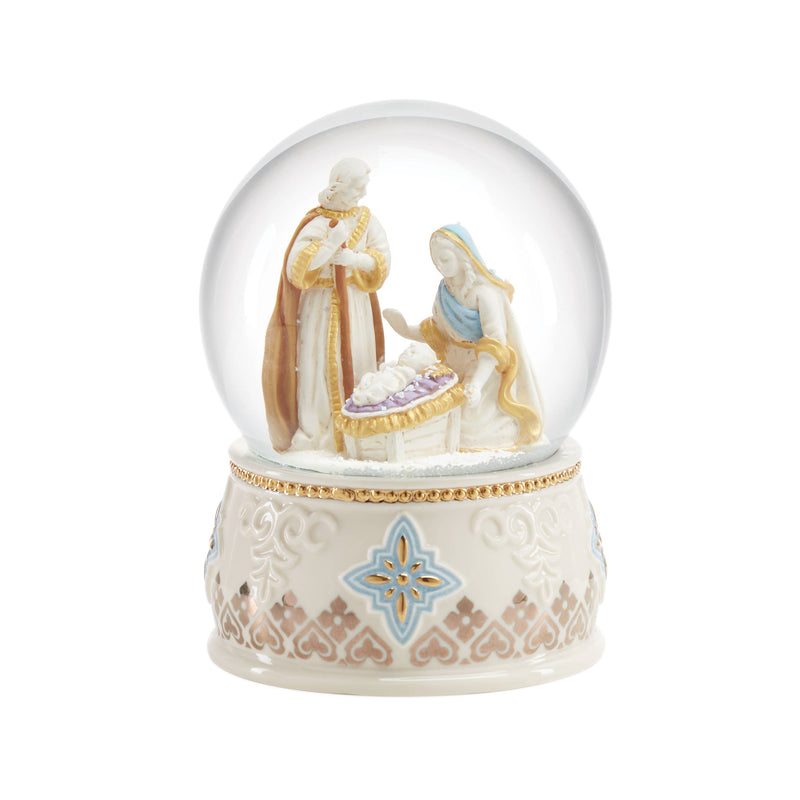Porcelain snow globe with nativity figures, gold trim, and blue star detail on white base