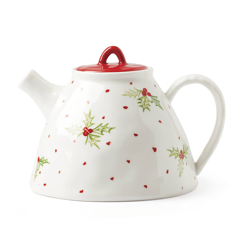 White porcelain teapot with red lid and holly berry pattern