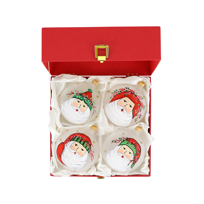 Set of four Christmas ornaments, white Santa face designs in open red gift box