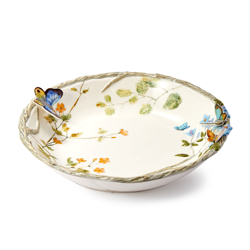 White ceramic serving bowl with butterfly and floral pattern, scalloped rim