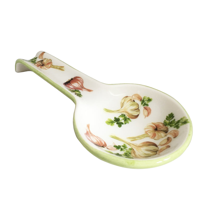 Ceramic spoon rest with white base, green rim, and garlic-herb floral design
