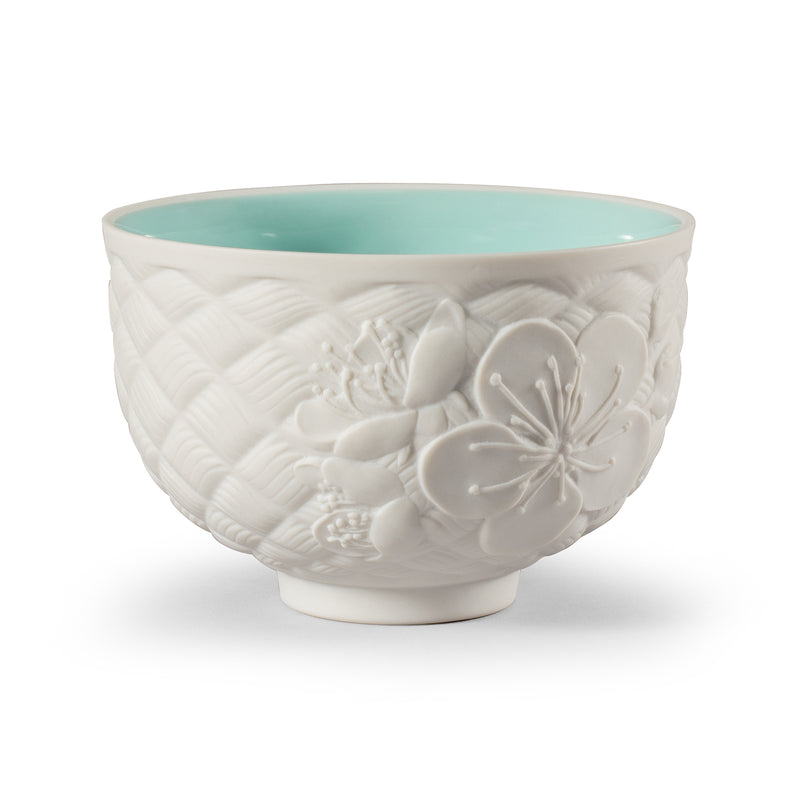Porcelain fall tea cup in white with embossed floral relief and teal rim