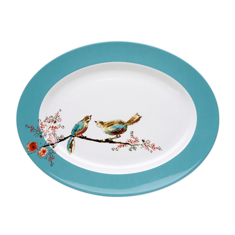 Large oval serving platter with teal rim, white center, and colorful bird illustration