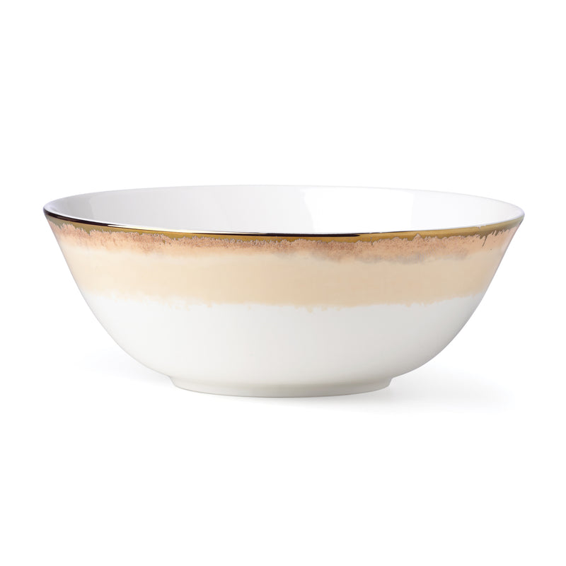 White ceramic serving bowl with gold rim and warm gold band detail