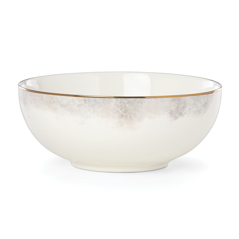 Porcelain serving bowl with soft cream finish and subtle gray marble pattern, gold rim
