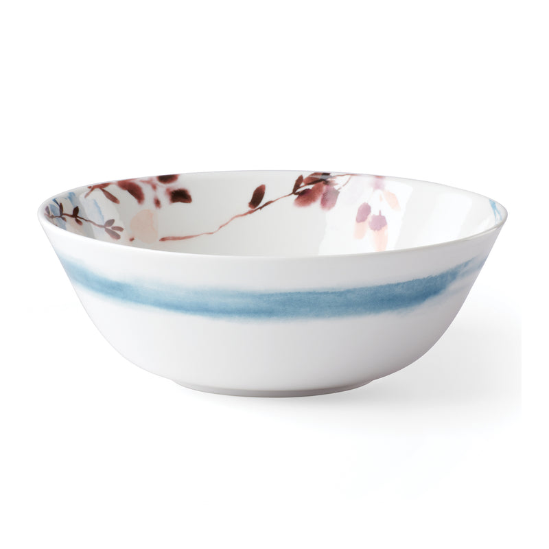 Porcelain serving bowl with white base, blue ombre band, and floral rim