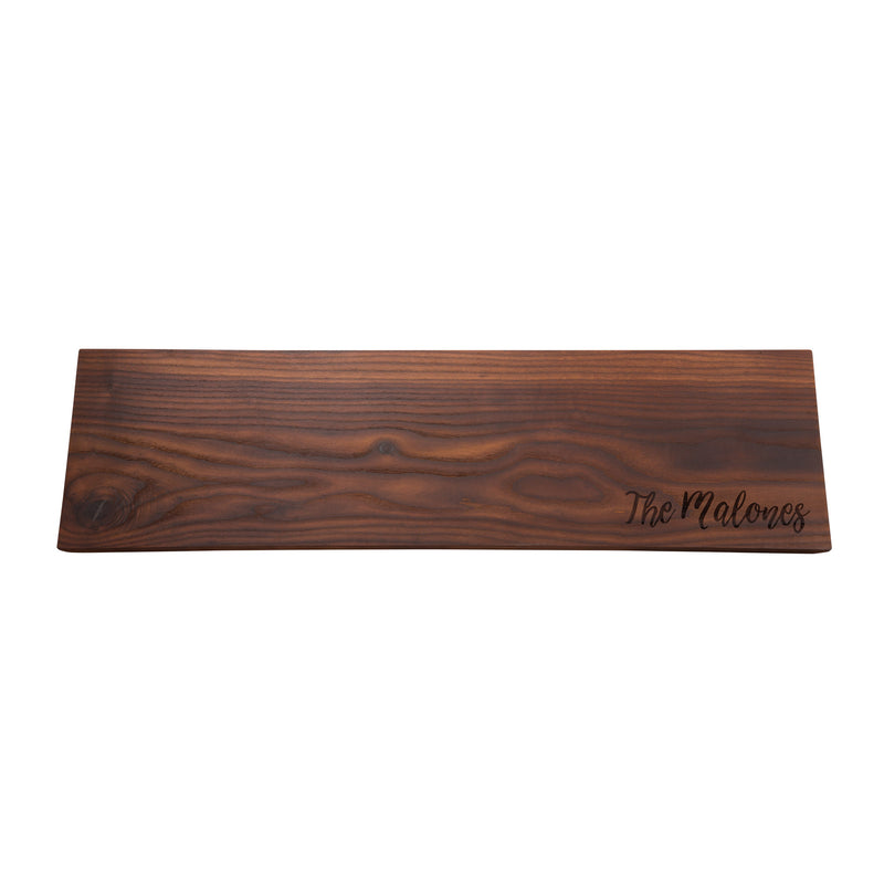Personalized charcuterie wooden plank board with engraved text on dark brown finish