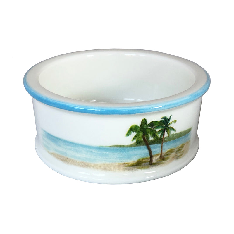 Round ceramic coaster with blue rim and palm tree beach scene illustration