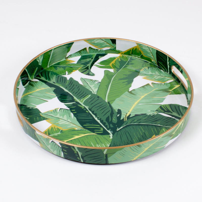 Leaf-print round tray with green tropical leaves and gold-toned edge.