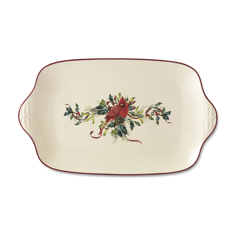 Cream oval decorative platter with red trim and winter floral cardinal centerpiece