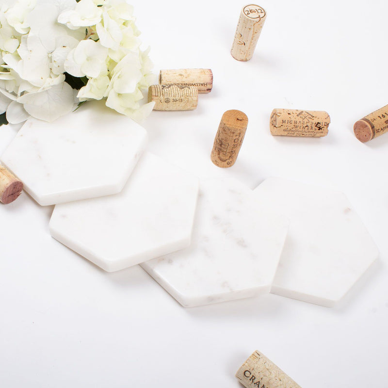 Set of four white marble hexagon coasters with cork backing