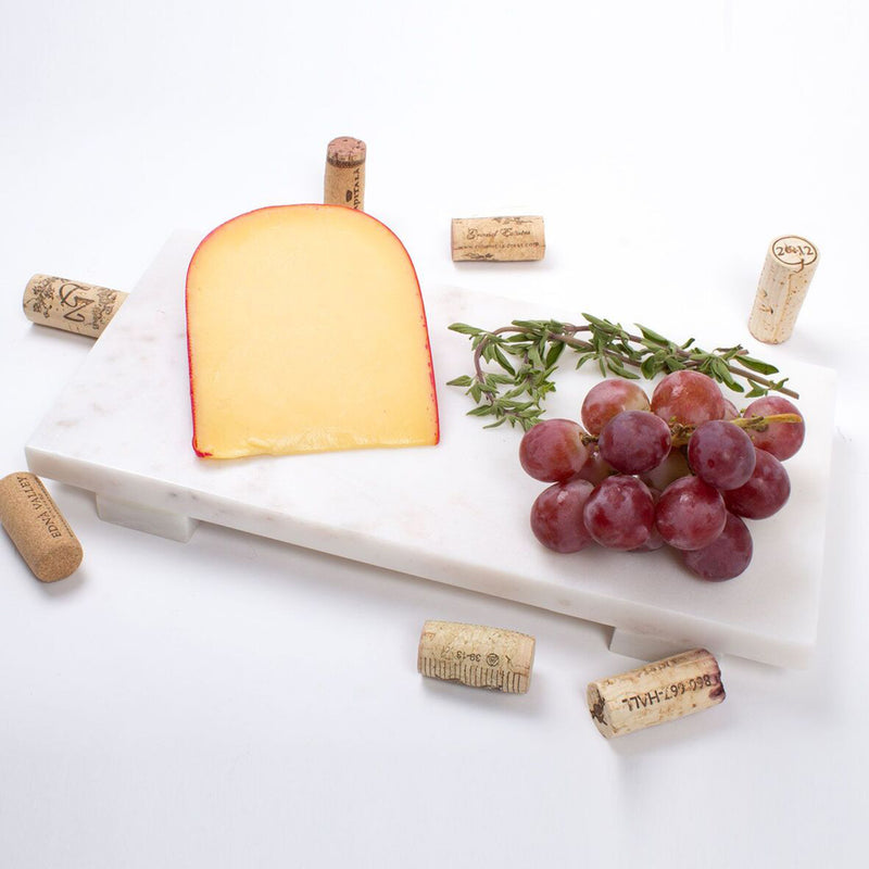 White marble cheese board with cork labels