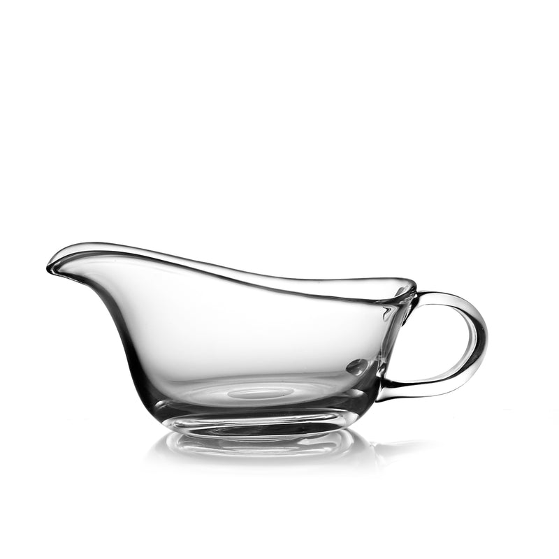 Nambe Moderne glass gravy boat with curved spout and loop handle, clear glass