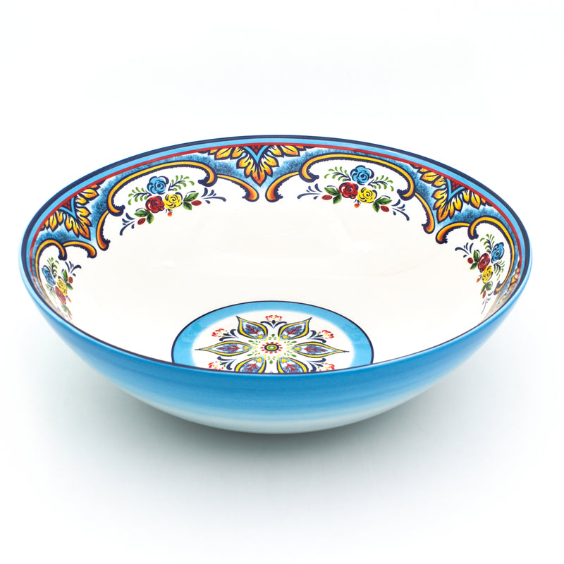 Blue ceramic serving bowl with white interior and colorful floral pattern