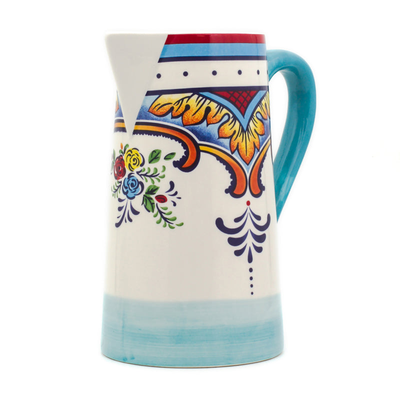 Ceramic pitcher with blue handle and colorful floral pattern on cream body