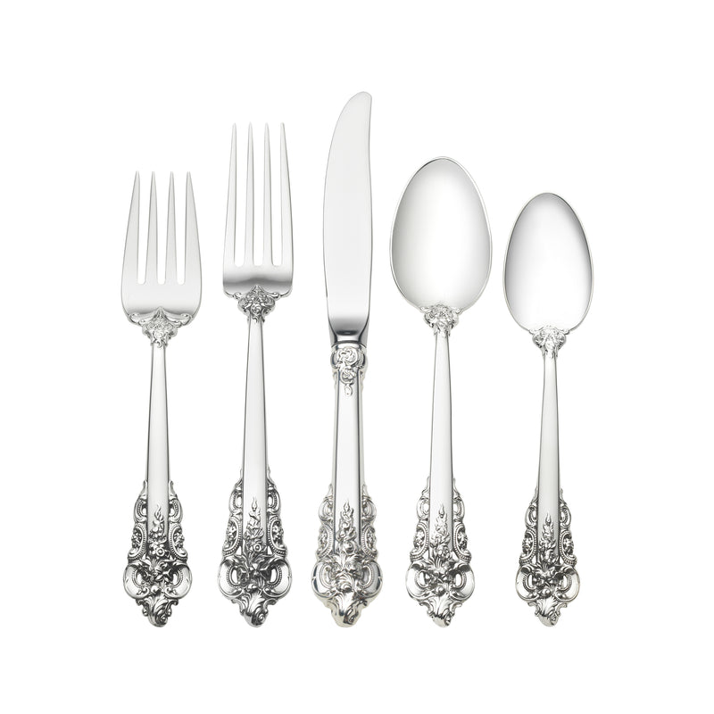 Sterling silver baroque place setting with fork, knife, and three spoons