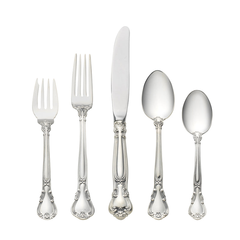 Sterling silver flatware set with ornate handles, includes forks and spoons